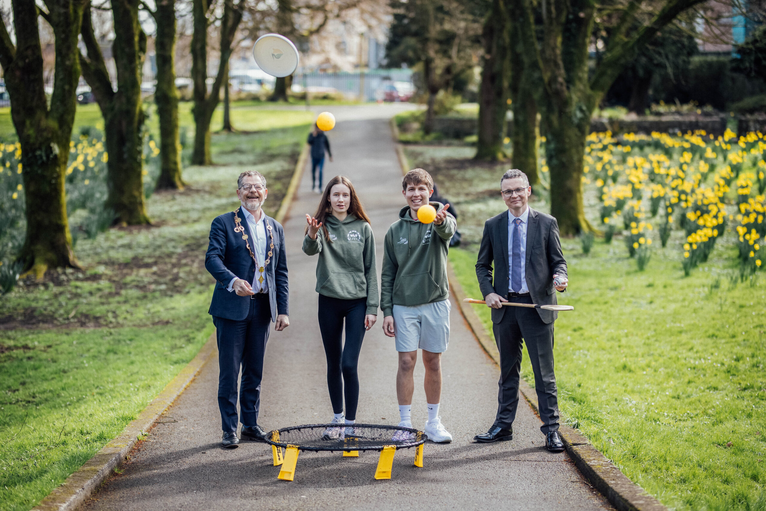 The Mayor of Limerick and Minister of Sport with two Limerick T.Y. students in a park