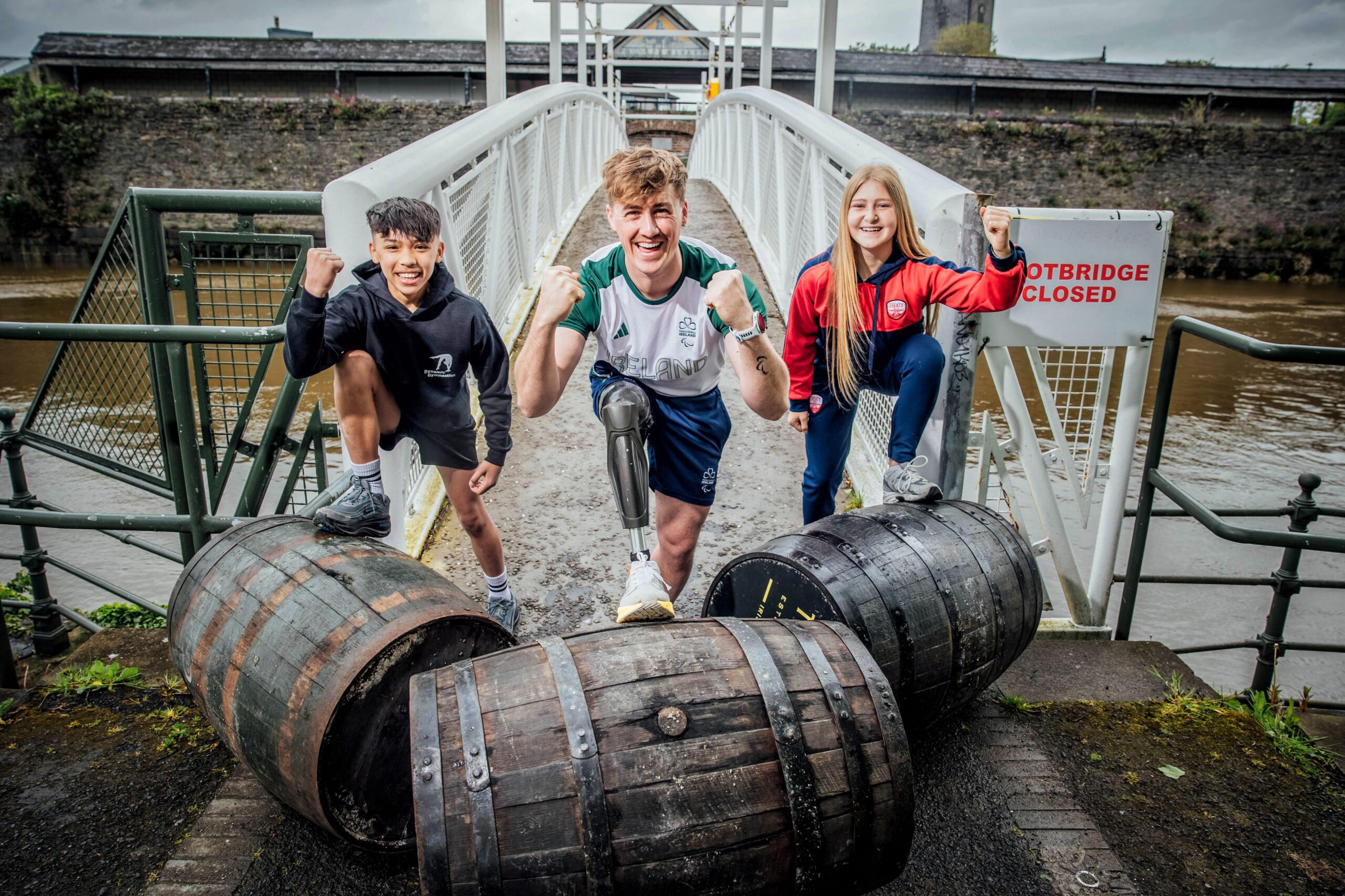 European Sport for All Launch 051 A young gymnast boy, Paralympian rower young man, and teen girl soccer player try out the traditional sport of French Barrel Rolling
